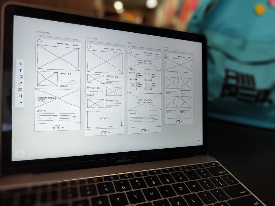 A website wireframe open on a laptop on a tidy desk